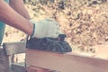 Carpenter working with electric planer on wooden plank Royalty Free Stock Photo