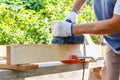 Carpenter working with electric planer on wooden plank Royalty Free Stock Photo