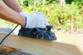 Carpenter working with electric planer on wooden plank Royalty Free Stock Photo