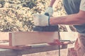 Carpenter working with electric planer on wooden plank Royalty Free Stock Photo