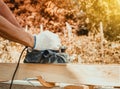 Carpenter working with electric planer on wooden plank Royalty Free Stock Photo