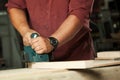 Carpenter working with electric planer. Royalty Free Stock Photo