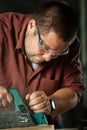 Carpenter working with electric planer. Royalty Free Stock Photo