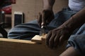 Carpenter working with gouge on table in his workshop