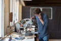 Carpenter working on his craft in a dusty workshop Royalty Free Stock Photo