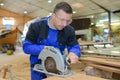 Carpenter working man cutting plank by circular saw Royalty Free Stock Photo