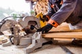 Carpenter working. Man cutting plank by circular saw. Royalty Free Stock Photo