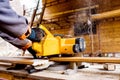 Carpenter working. Man cutting plank by circular saw. Royalty Free Stock Photo
