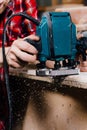 Carpenter working of manual hand milling machine in the carpentry workshop. joiner. Royalty Free Stock Photo