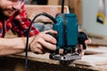 Carpenter working of manual hand milling machine in the carpentry workshop. joiner. Royalty Free Stock Photo