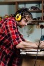 Carpenter working of manual hand milling machine in the carpentry workshop. joiner. Royalty Free Stock Photo