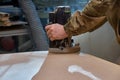 Carpenter working with manual hand milling machine in the workshop. Wooden furniture manufacturing process Royalty Free Stock Photo