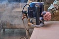 Carpenter working with manual hand milling machine in the workshop. Wooden furniture manufacturing process Royalty Free Stock Photo