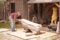 Carpenter working outside on wooden part