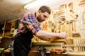 Carpenter working with plane and wood at workshop Royalty Free Stock Photo