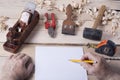 Carpenter working with plane on wooden background at Building Site. Joiner workplace