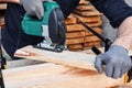 Carpenter working with plane on wooden background. Man hand with professional instrument building construction