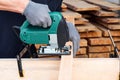 Carpenter working with plane on wooden background. Man hand with professional instrument, building construction