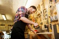 Carpenter working with saw and wood at workshop Royalty Free Stock Photo