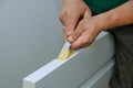 Carpenter working using a chisel a hinge wooden door installation a hinge