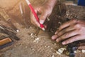 Carpenter working on woodwork using a pencil marking and draw on the wood board a man working in workshop Royalty Free Stock Photo