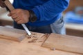 Carpenter working on woodworking machines in carpentry shop Royalty Free Stock Photo