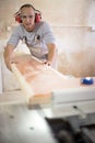 Carpenter working on woodworking machines in carpentry shop Royalty Free Stock Photo