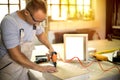 Carpenter working on woodworking machines in carpentry shop Royalty Free Stock Photo