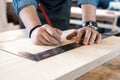 Carpenter working on woodworking machines in carpentry shop. A man works in a carpentry shop. Royalty Free Stock Photo