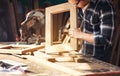 Carpenter working on woodworking machines in carpentry shop. A man works in a carpentry shop Royalty Free Stock Photo