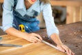 Carpenter working on woodworking machines in carpentry shop. woman works in a carpentry shop Royalty Free Stock Photo