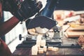 Carpenter working on woodworking machines in carpentry shop, wooden product Royalty Free Stock Photo