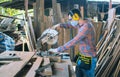 A carpenter is working in a woodworking office.caucasion white male carpenter using electric circular saw cut wood Royalty Free Stock Photo