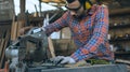 A carpenter is working in a woodworking office.caucasion white male carpenter using electric circular saw cut wood Royalty Free Stock Photo