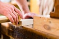 Carpenter with workpiece in carpentry Royalty Free Stock Photo
