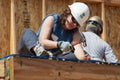 Carpenter works on building roof of new home Royalty Free Stock Photo