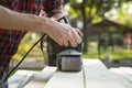 The carpenter works with the electric polisher