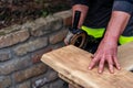 A carpenter works in a garden Royalty Free Stock Photo