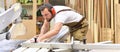 carpenter works in a joinery - workshop for woodworking and sawing