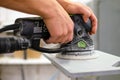 A carpenter works on wood in a carpentry workshop. Grinding tools Royalty Free Stock Photo