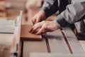 A carpenter works on woodworking the machine tool. Carpenter working on woodworking machines in carpentry shop. Royalty Free Stock Photo