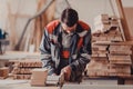 A carpenter works on woodworking the machine tool. Carpenter working on woodworking machines in carpentry shop. Royalty Free Stock Photo