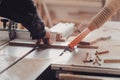 A carpenter works on woodworking the machine tool. Carpenter working on woodworking machines in carpentry shop. Royalty Free Stock Photo