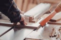 A carpenter works on woodworking the machine tool. Carpenter working on woodworking machines in carpentry shop. Royalty Free Stock Photo