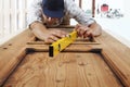 Carpenterr work the wood measuring with spirit level Royalty Free Stock Photo
