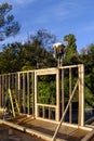 Carpenters framing a new exterior wall on deck