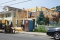 Carpenters framing out a new home on a tall raised foundation