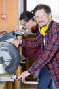 carpenters using circular saw in workshop Royalty Free Stock Photo