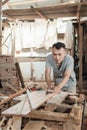 Carpenters work using traditional dowels to smooth the surfaces of wood planks