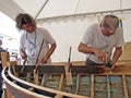 Carpenters are working on the old wooden boat restoration